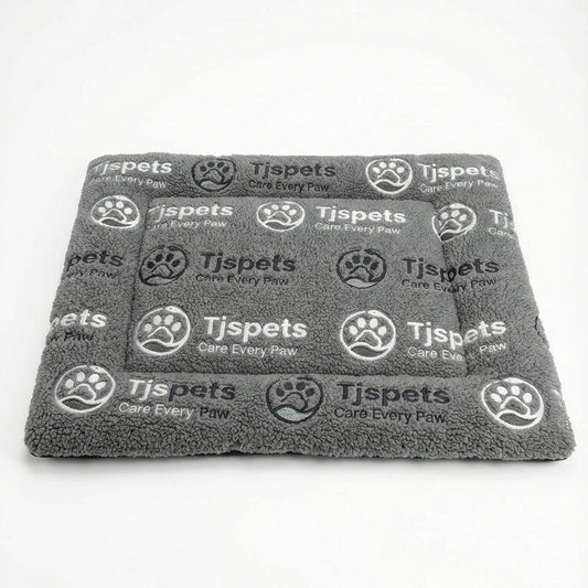 Gray towel with 'Tjspets' branding on a white background
