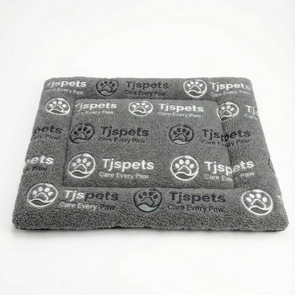 Gray towel with 'Tjspets' branding on a white background