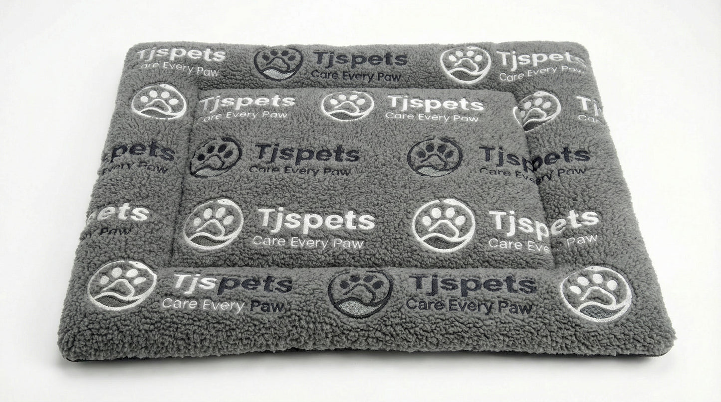 Gray pet blanket with Tjspets branding on a white background